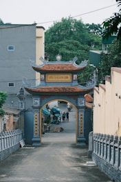 A decorative gate leads into a village street.