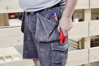 A carpenter's tool-filled pocket shows his trade.