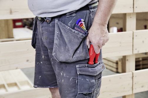 A carpenter's tool-filled pocket shows his trade.