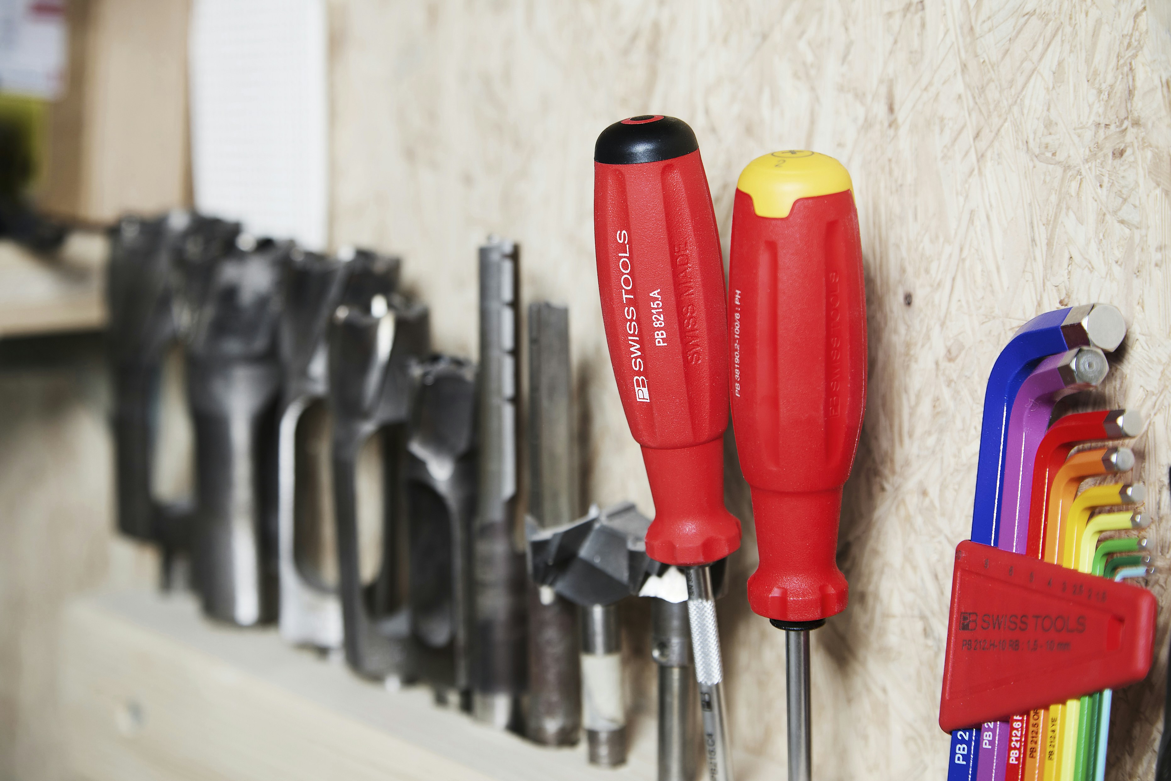Tools arranged on a wooden wall.