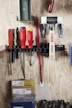 Tools are organized neatly on a wooden wall.