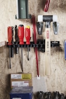 Tools are organized neatly on a wooden wall.