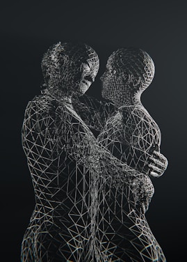 Two wireframe figures embrace affectionately against black.