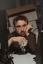 Man is bored and holding a coffee cup.