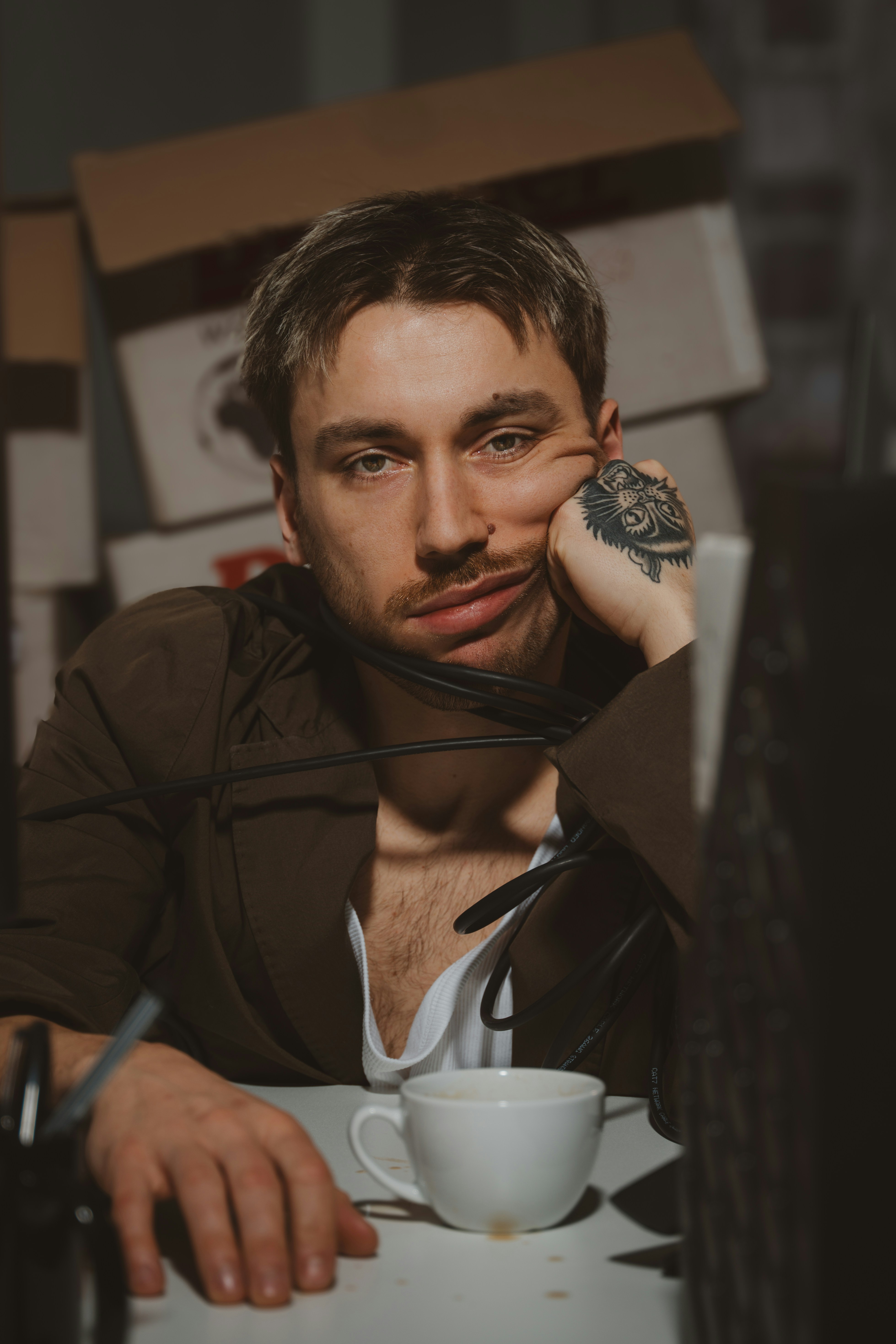 A tired man sits at his desk.