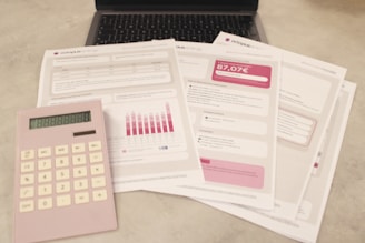 Bills, calculator, and a laptop: financial tasks underway.
