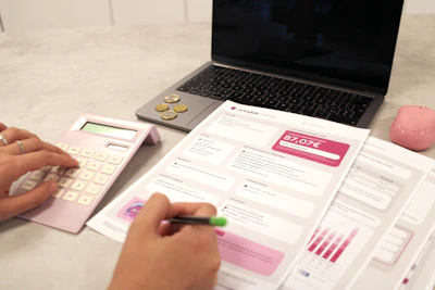 Someone is calculating their finances with documents.