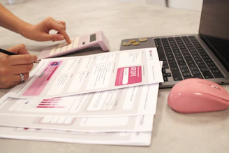 Someone is calculating bills with a calculator.