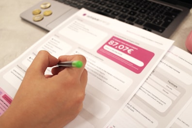 Person reviews a bill with a pen.