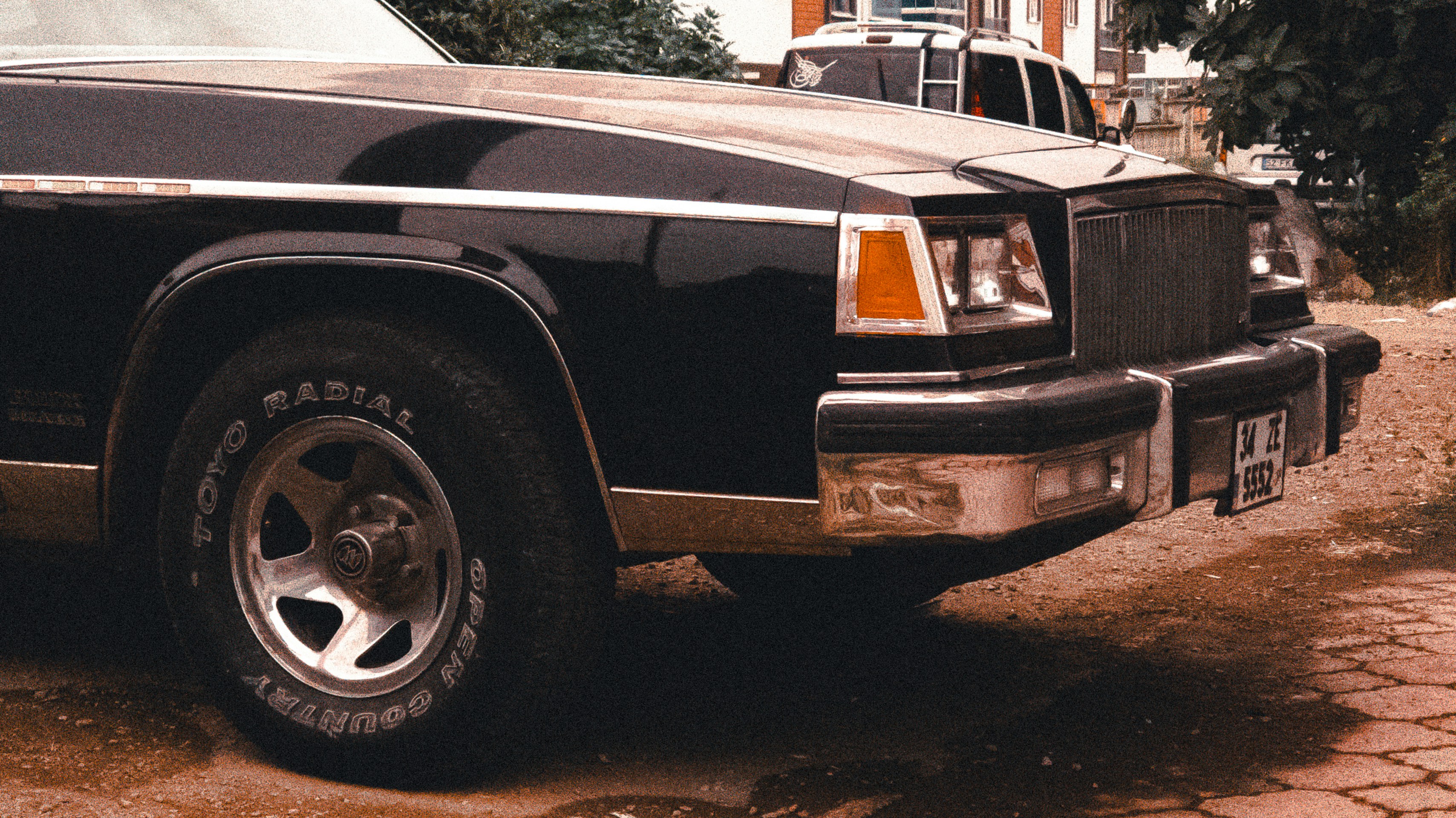 A black vintage car sits outdoors.