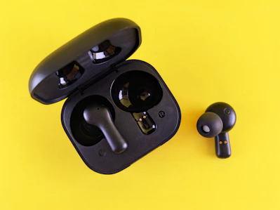 Black earbuds and their charging case.