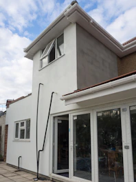 A house under construction, showing added extensions.