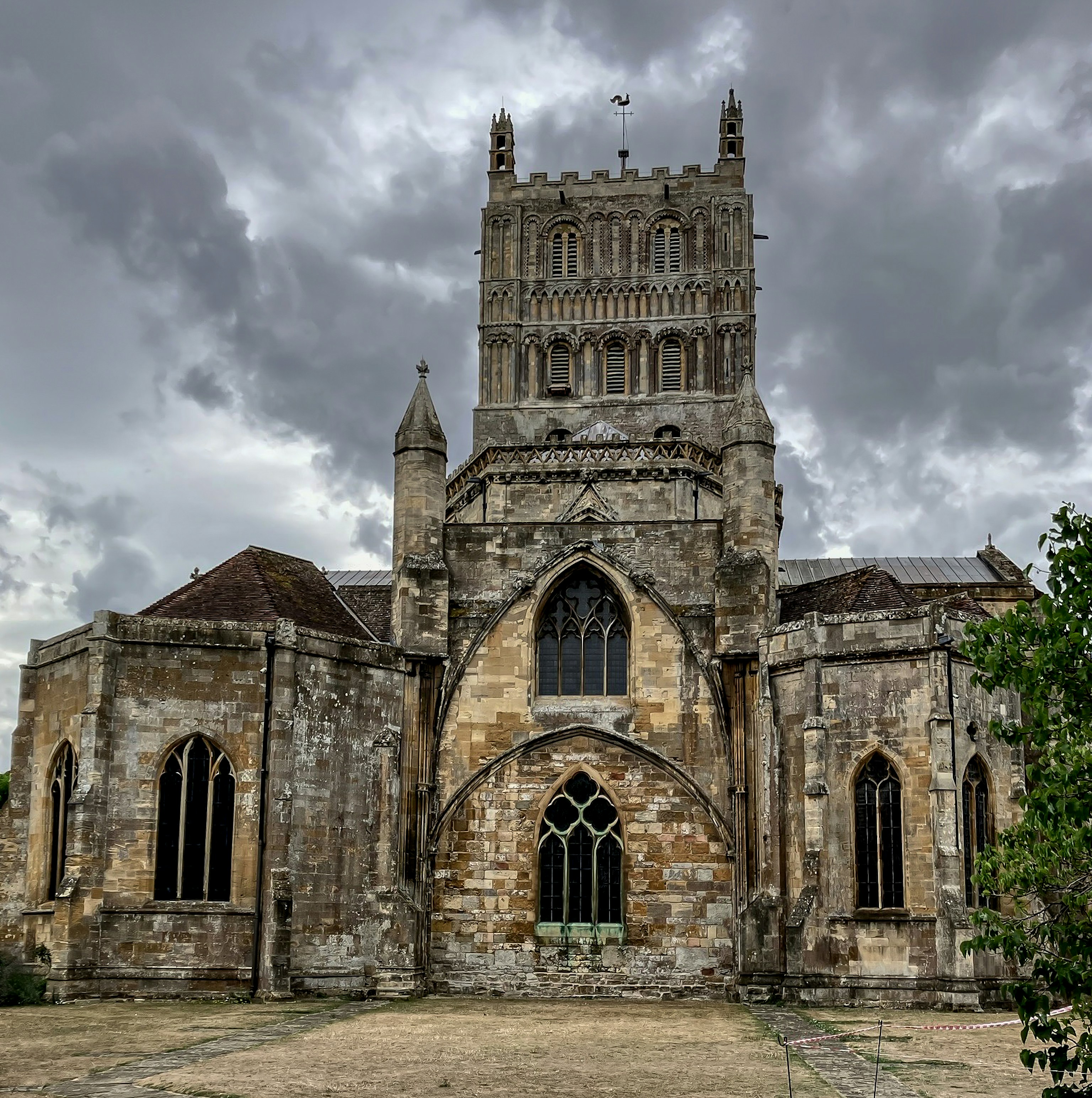 An ancient church stands beneath a cloudy sky.