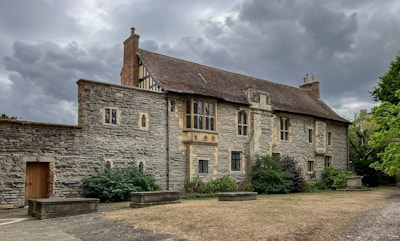 Historic stone building with a large roof.