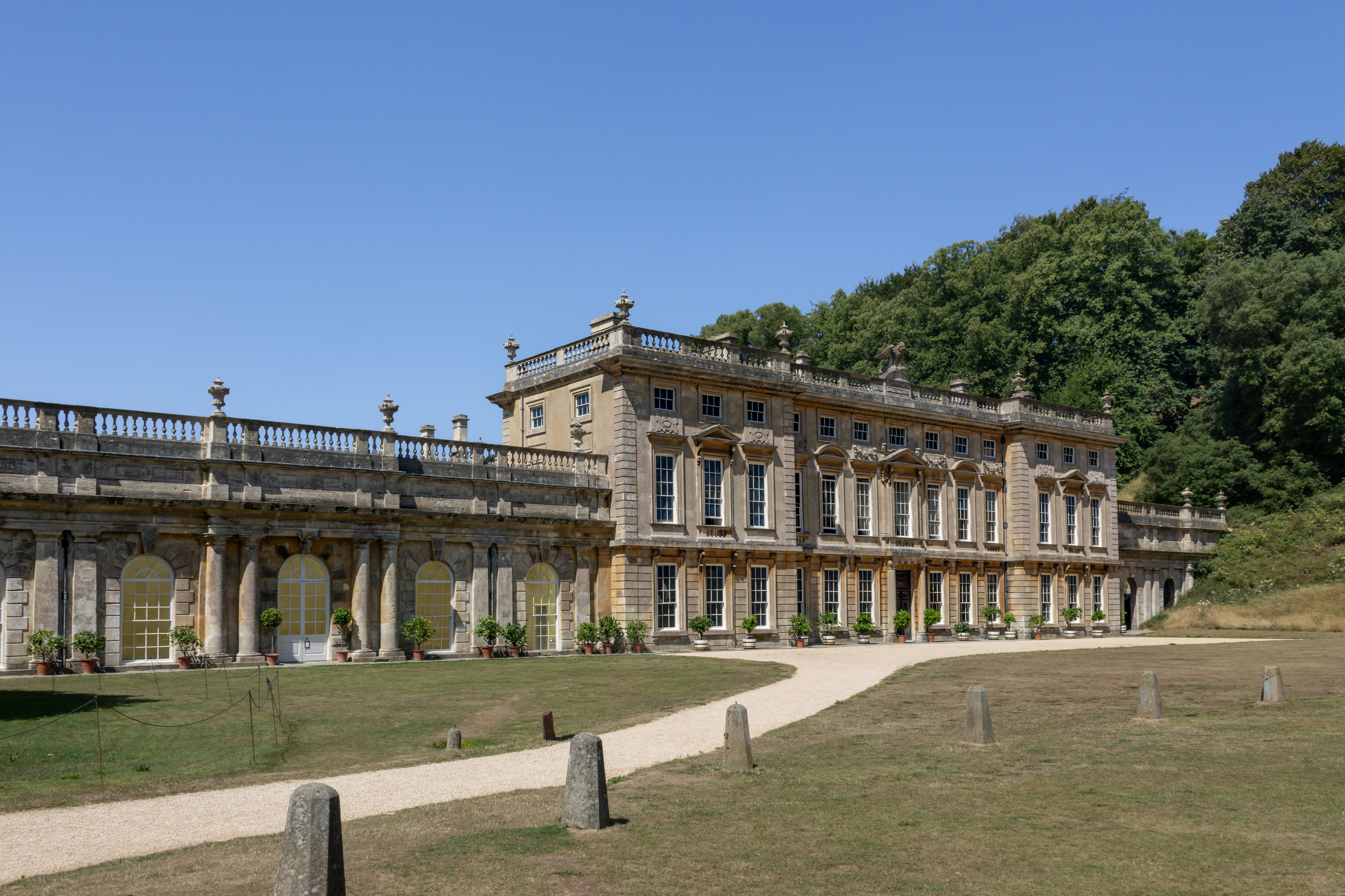 A large, beautiful mansion stands against a blue sky.