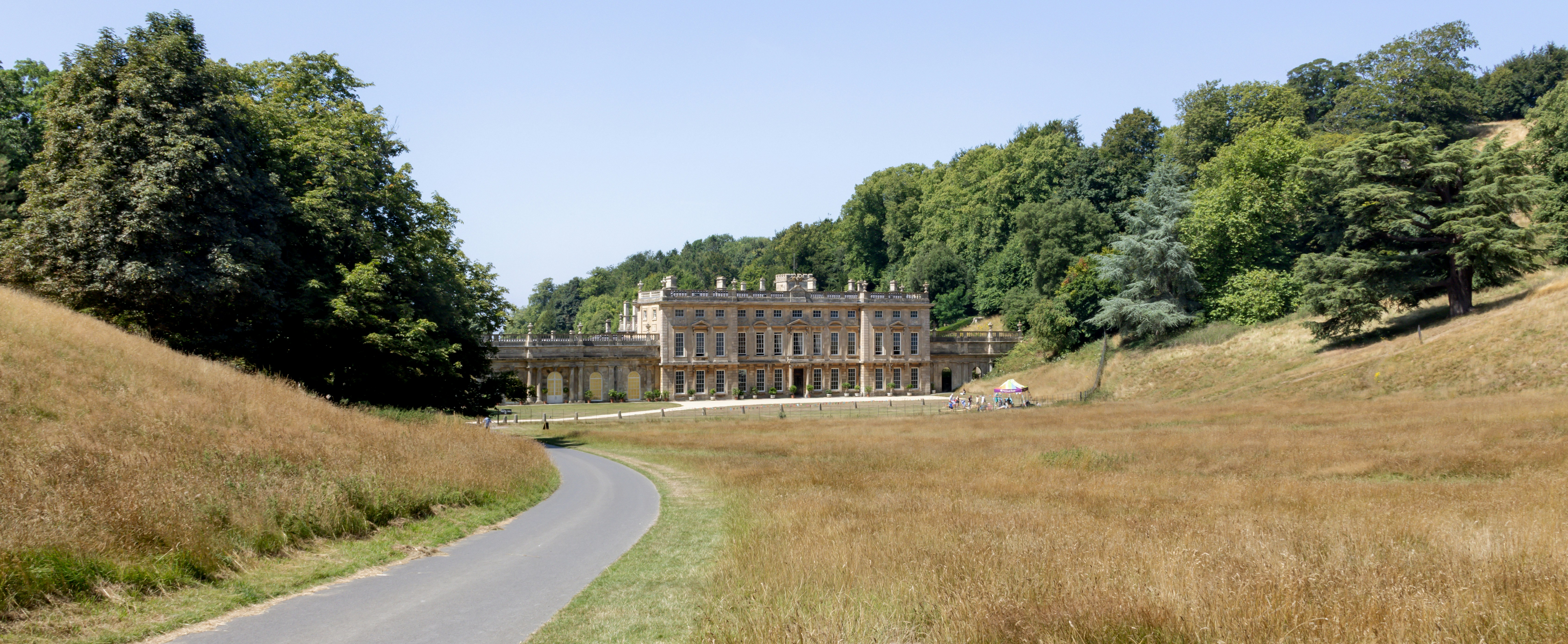 A mansion sits at the end of a winding road.