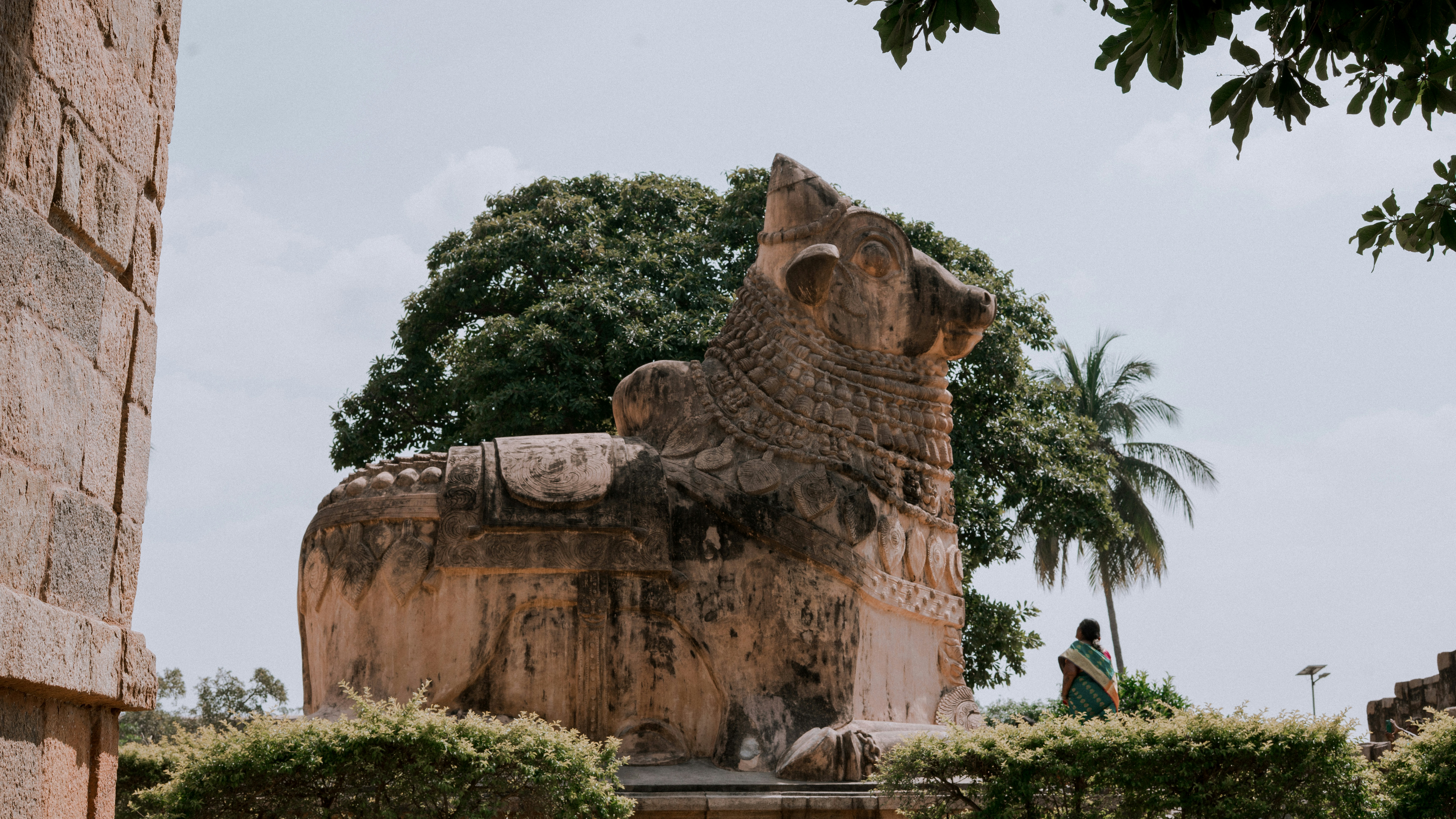 A stone bull sculpture stands proudly outside.