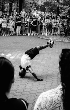 A street performer doing a headstand for the crowd.