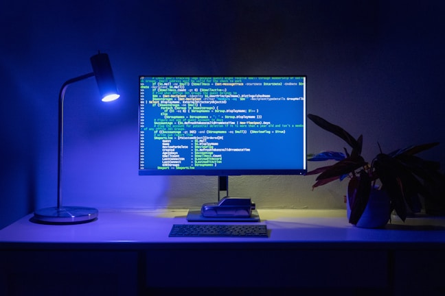 Code appears on a computer screen.