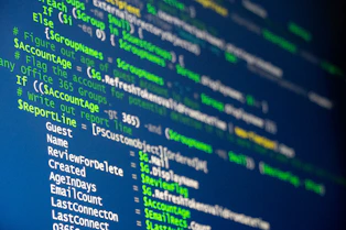 Computer code is displayed on a screen.