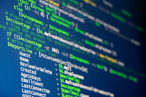 Computer code is displayed on a screen.