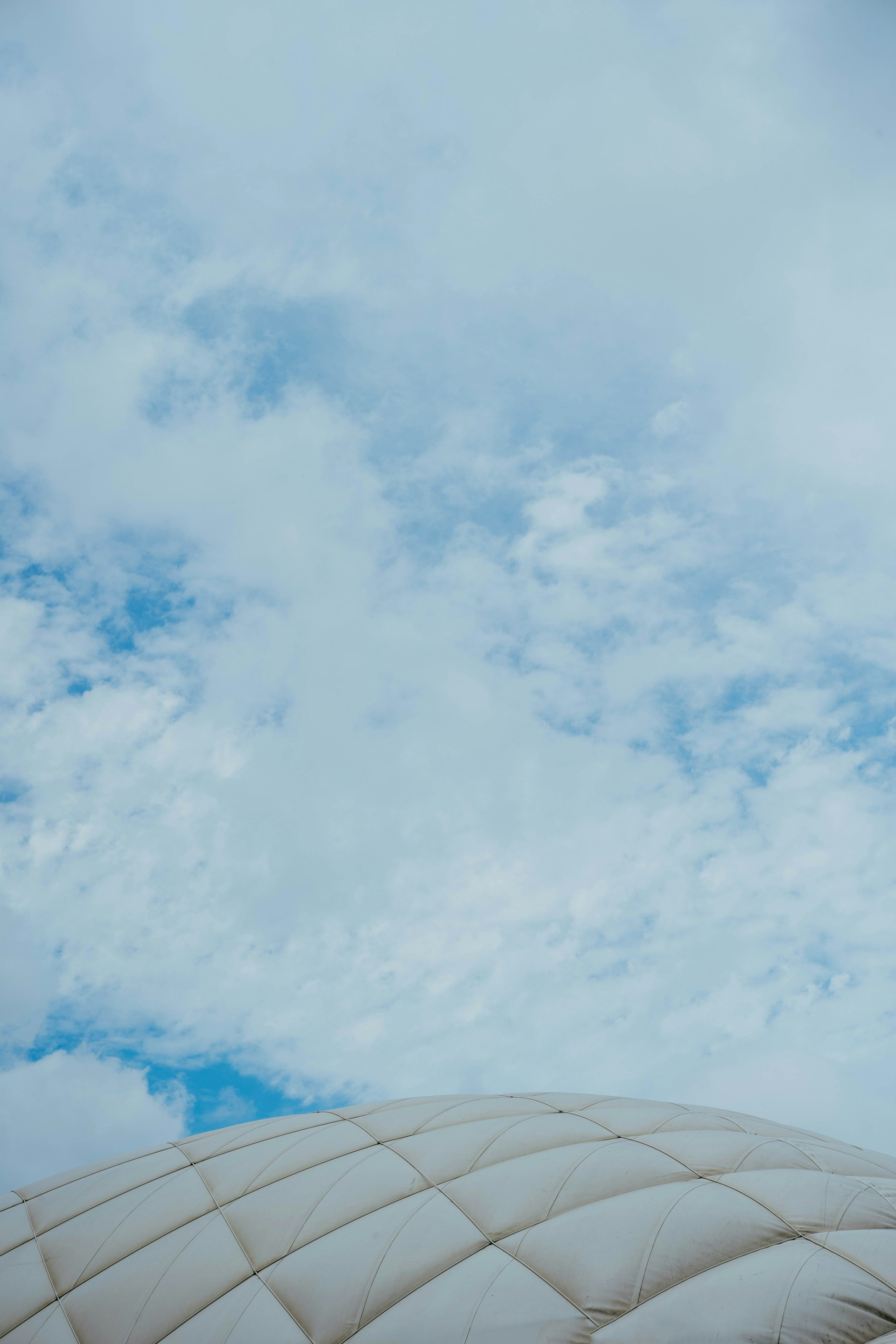 White dome against a cloudy, blue sky.