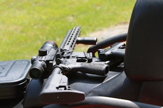 An ar-15 rifle sits on a vehicle.