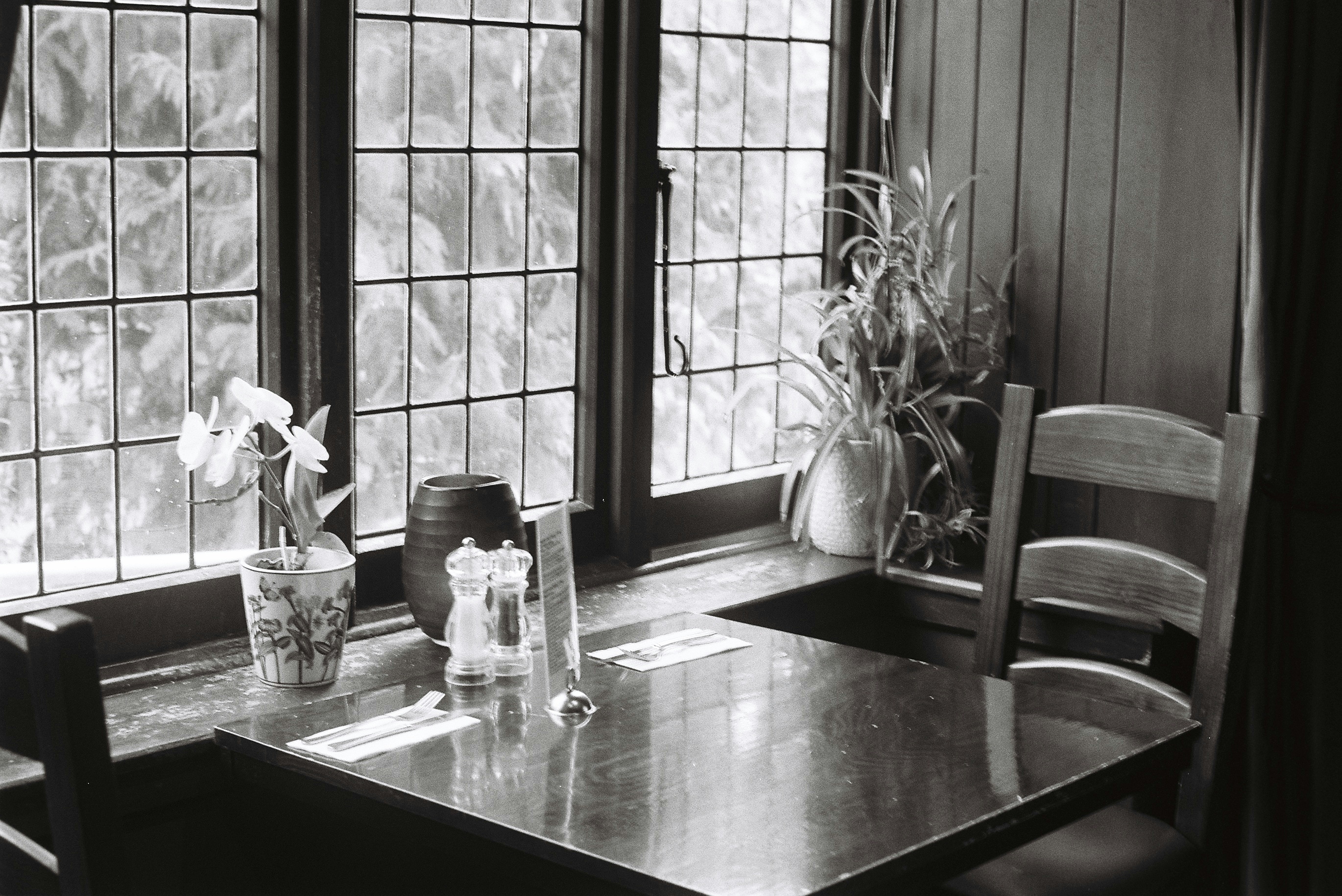 Cozy dining table sits by a window.