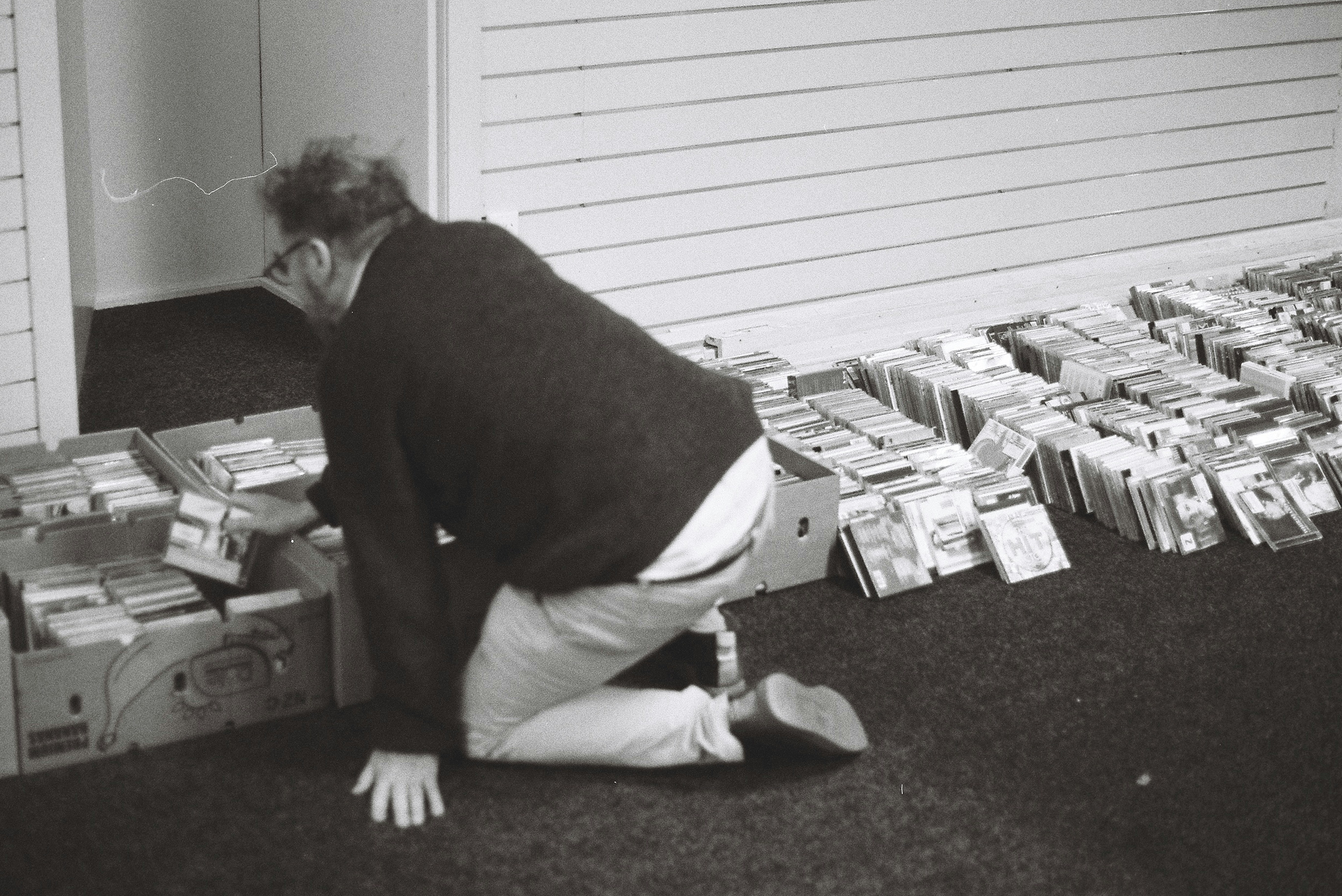 Man sorts through a large collection of items.