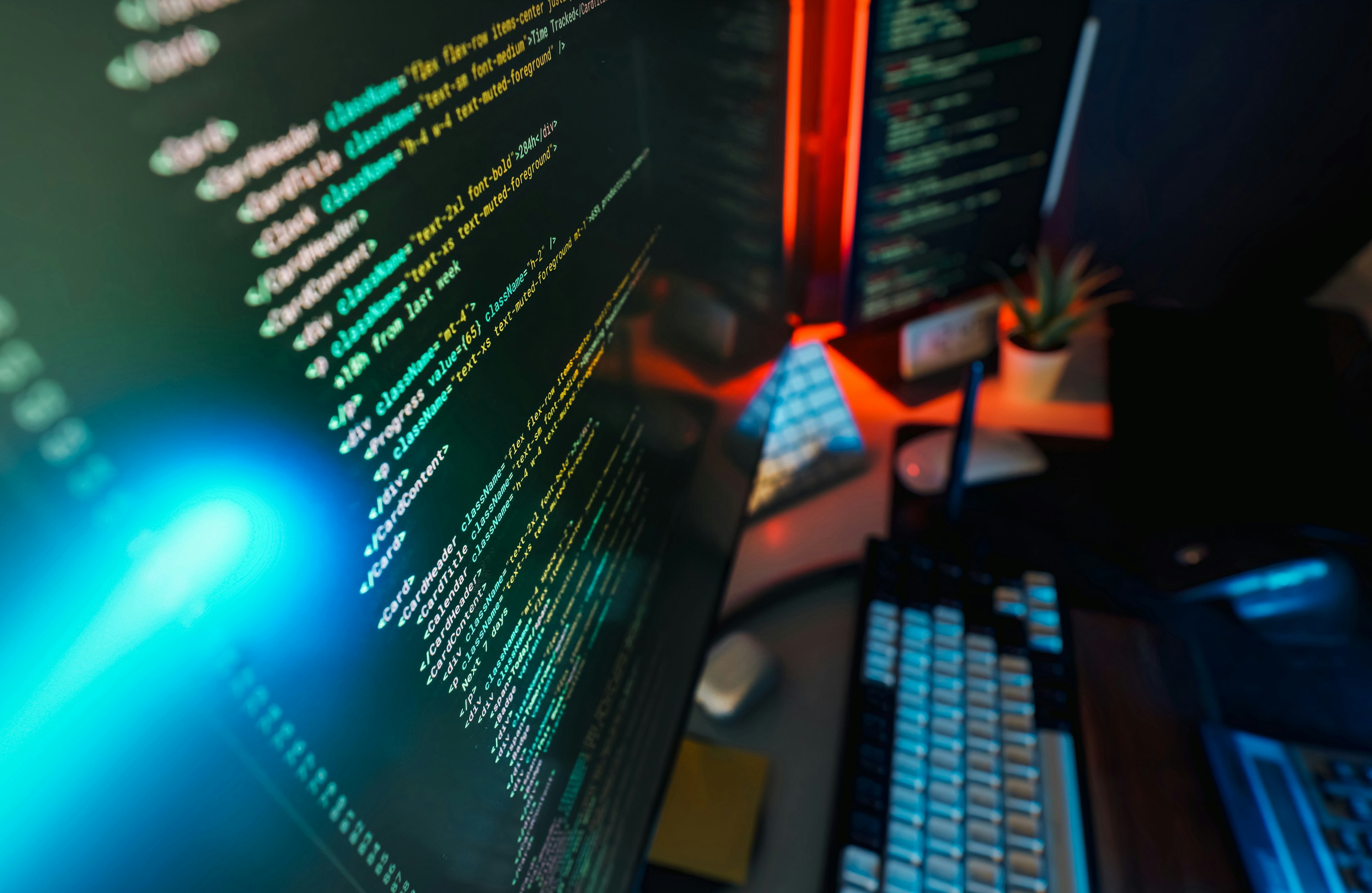 cybersecurity engineer analyzing code on multiple monitors in dark office