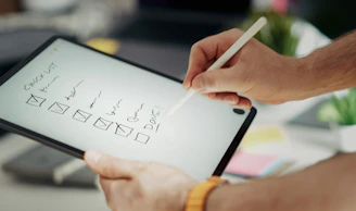 Writing on a checklist with a stylus.