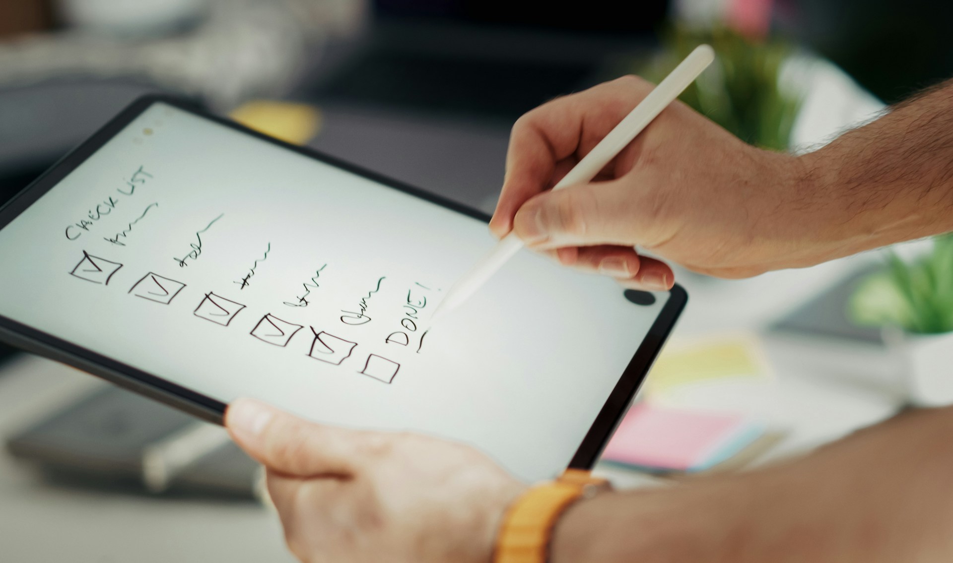 Writing on a checklist with a stylus.
