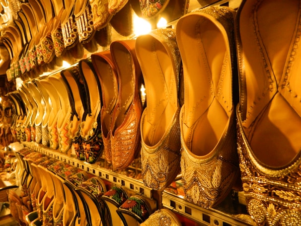 Shoes are displayed on shelves in a shop.