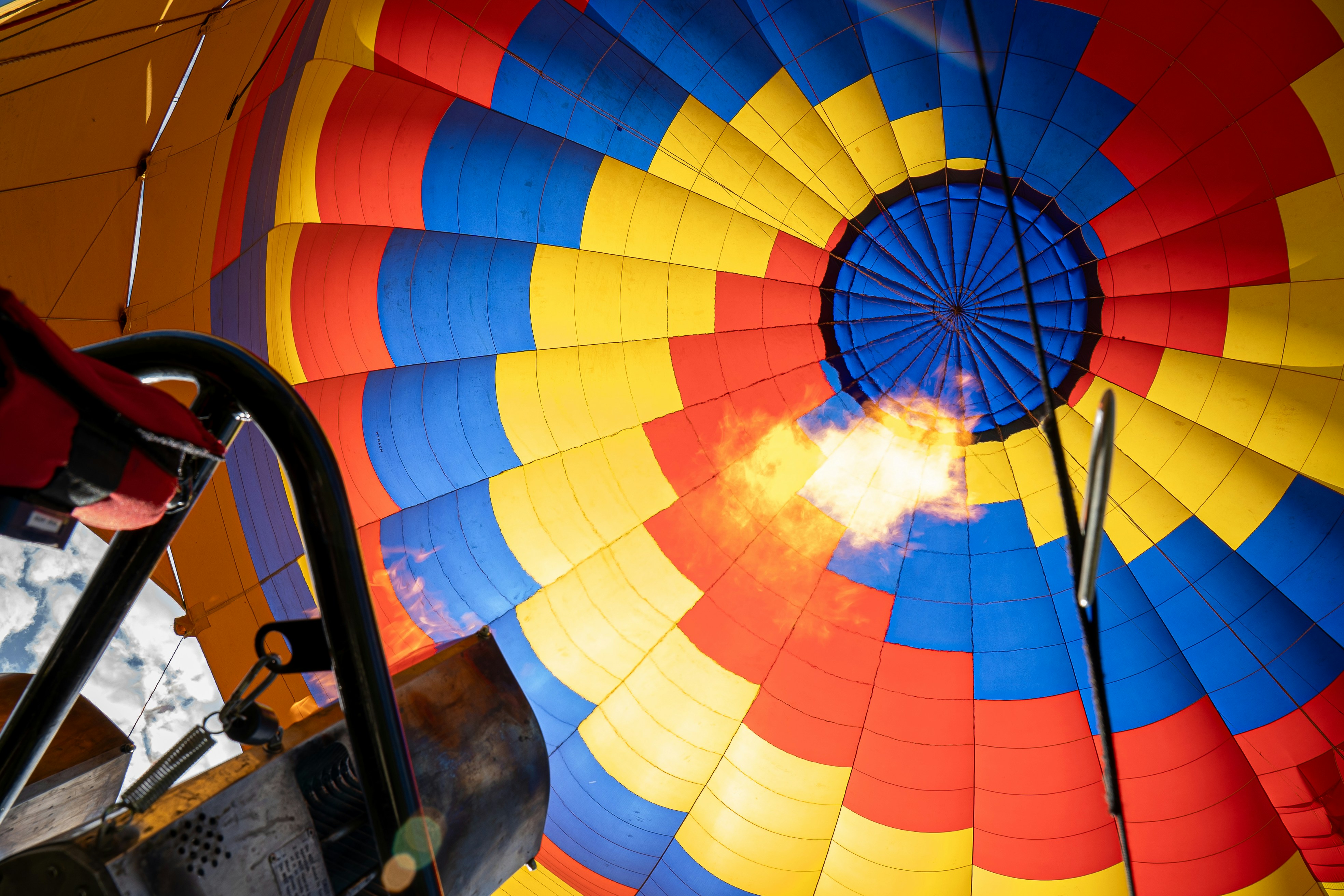 Flames heat a colorful hot air balloon.