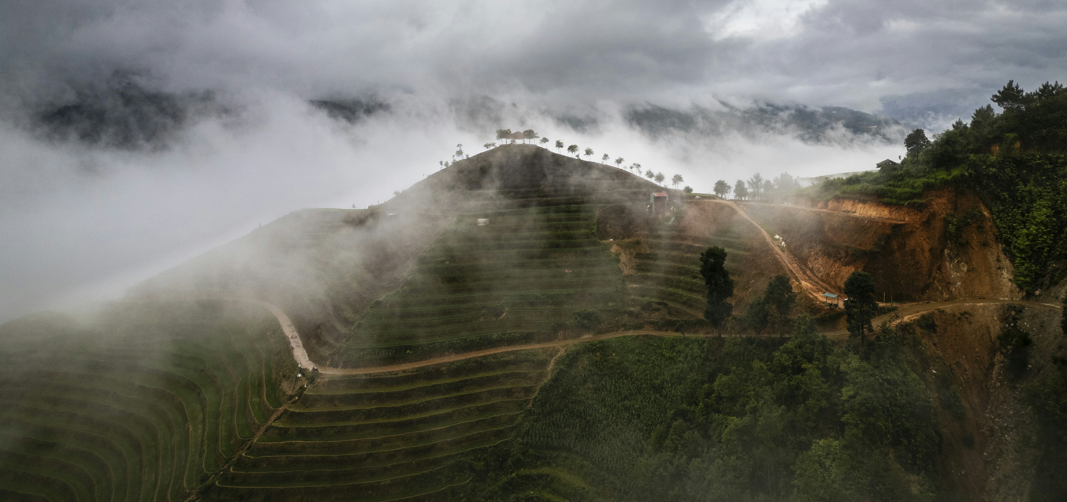 Mountain landscape shrouded in mist and clouds.