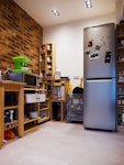 A compact, modern kitchen with a brick wall.