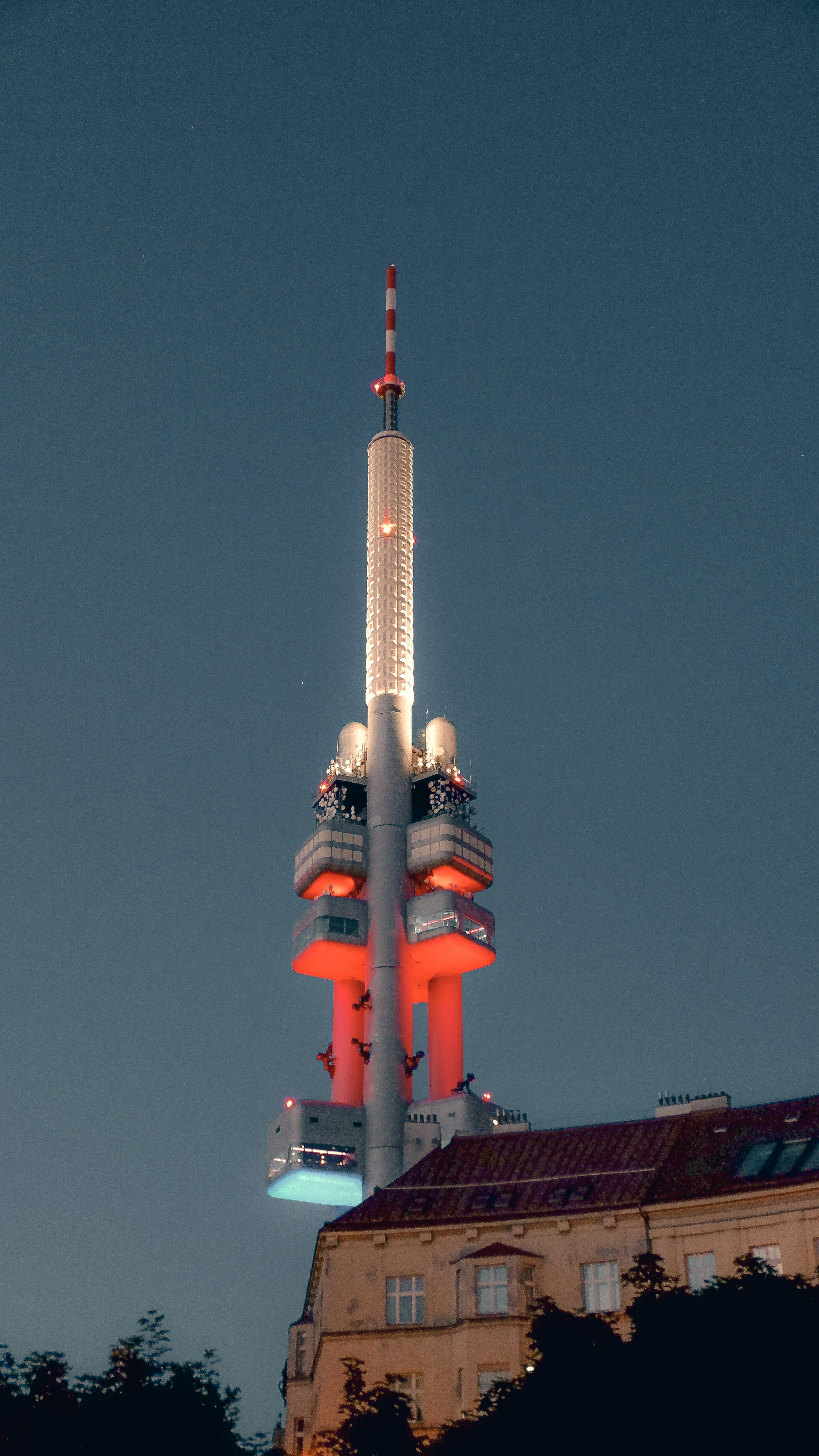 Nighttime view of the illuminated zizkov TV tower.