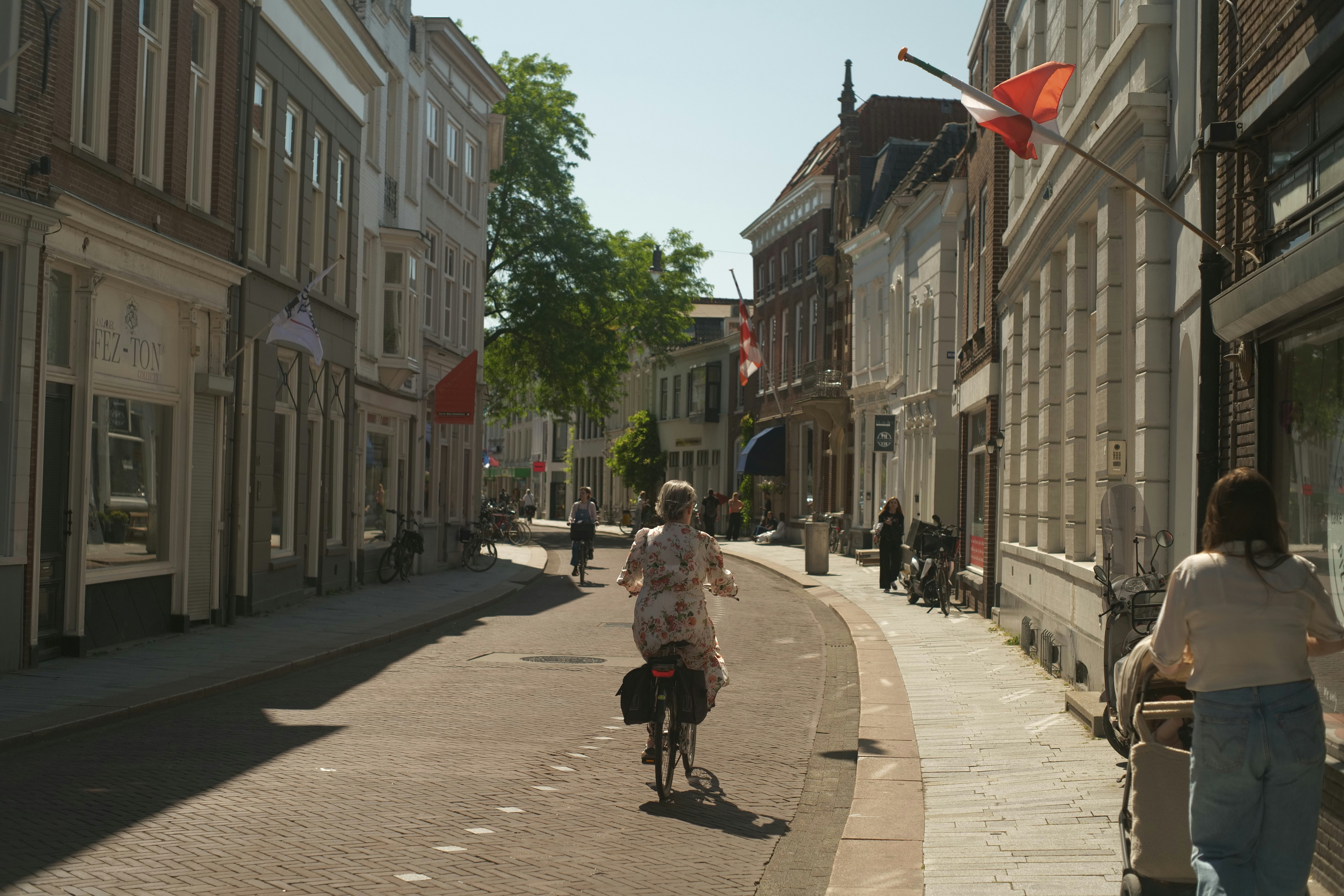 A person rides a bike down a city street.