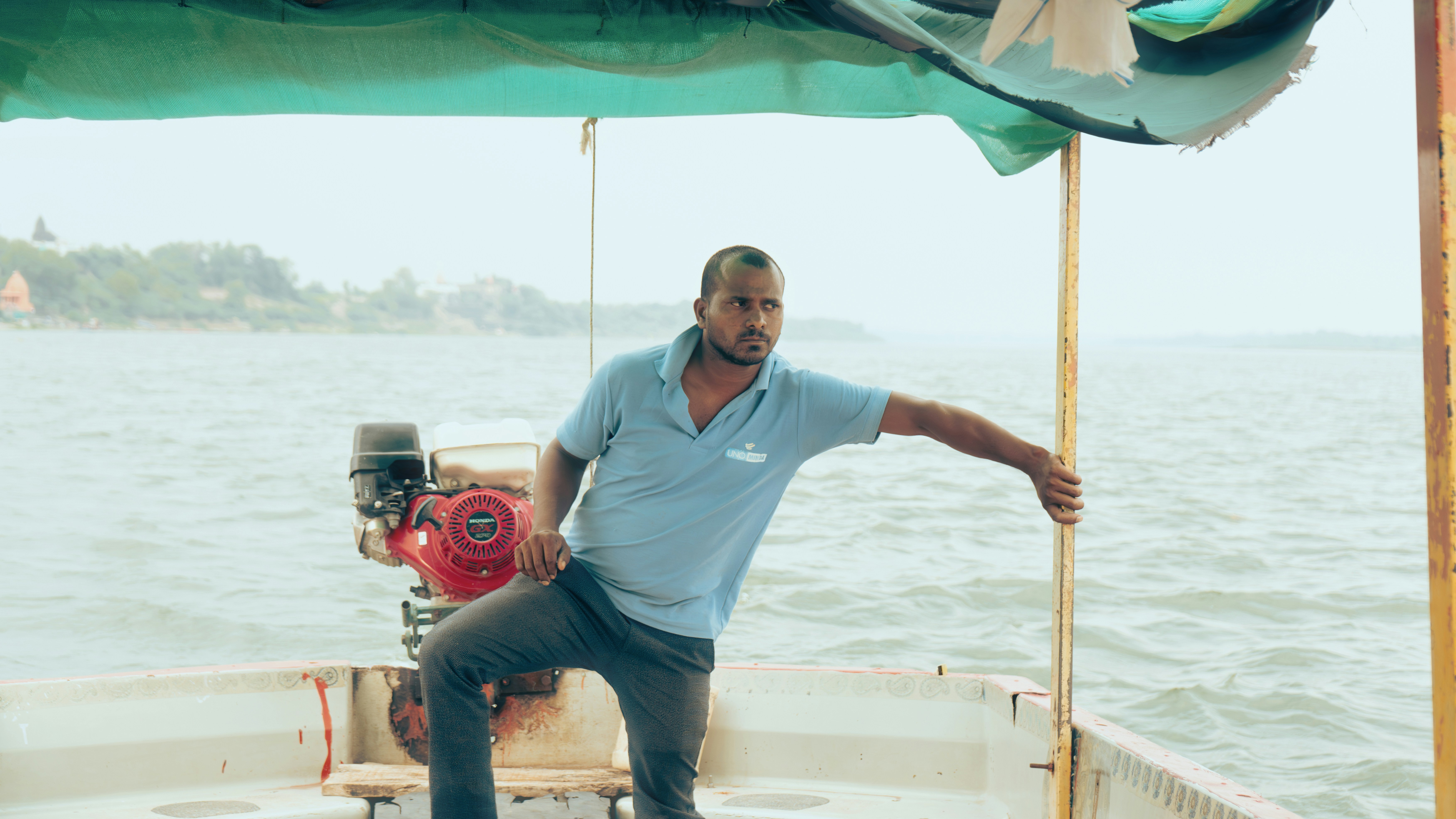 Two men on a boat with water in background