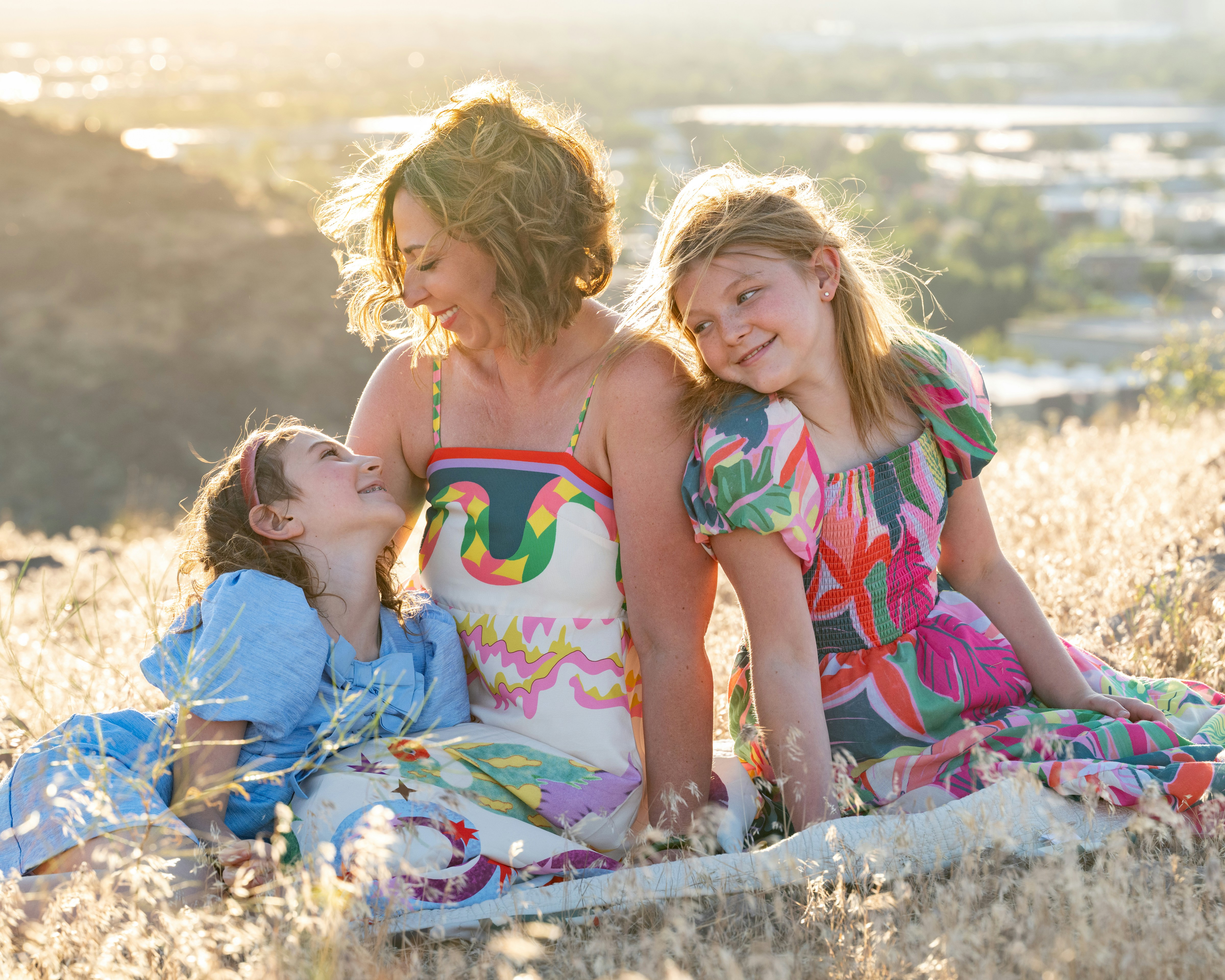 Mother and daughters at sunset