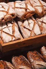Freshly baked loaves of bread are piled high.