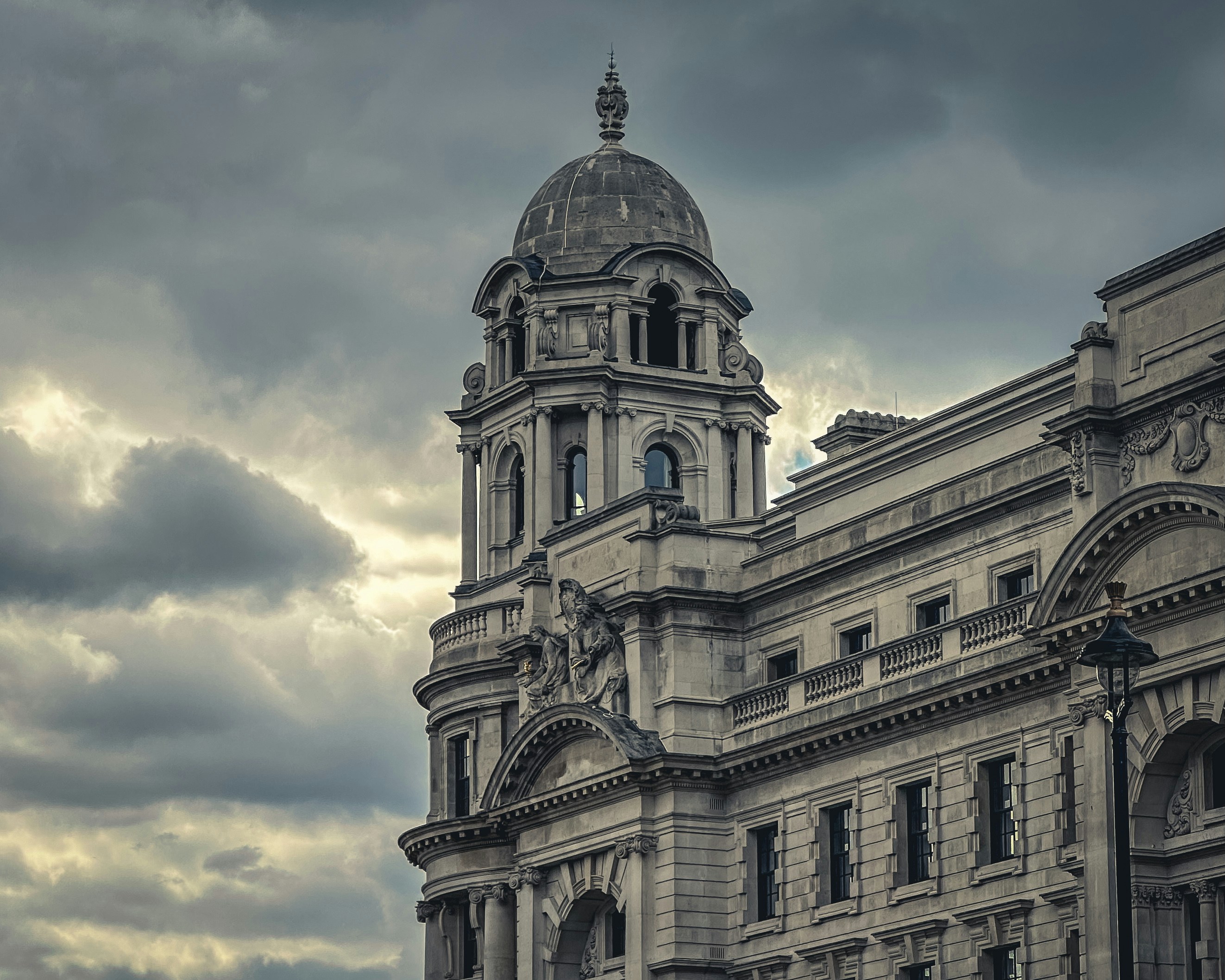 An ornate building with a cloudy sky background.