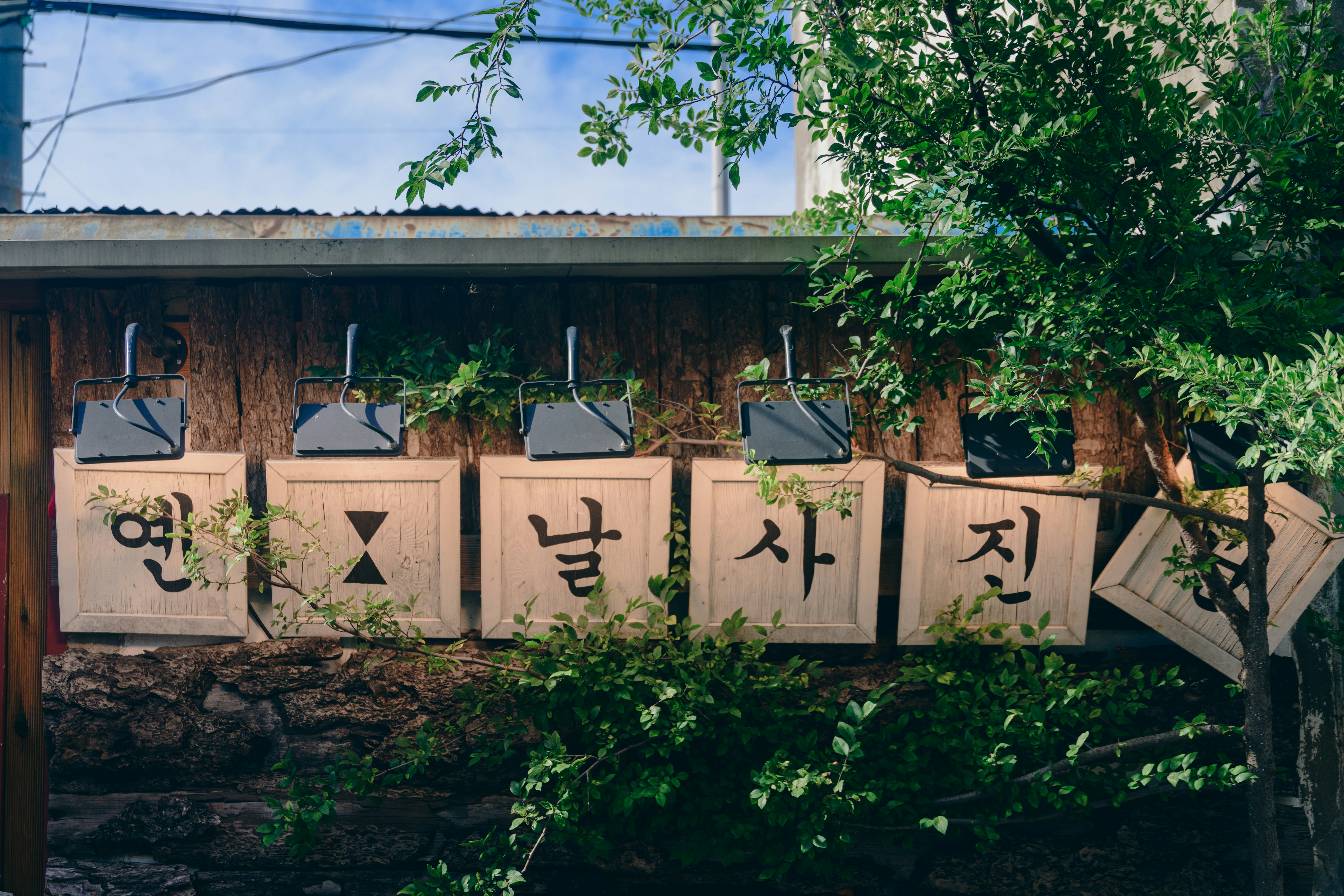 Korean signage hangs above a wooden wall.