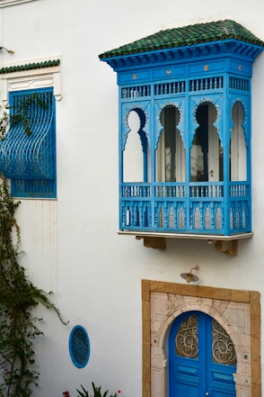 Beautiful, blue balcony on a white building.