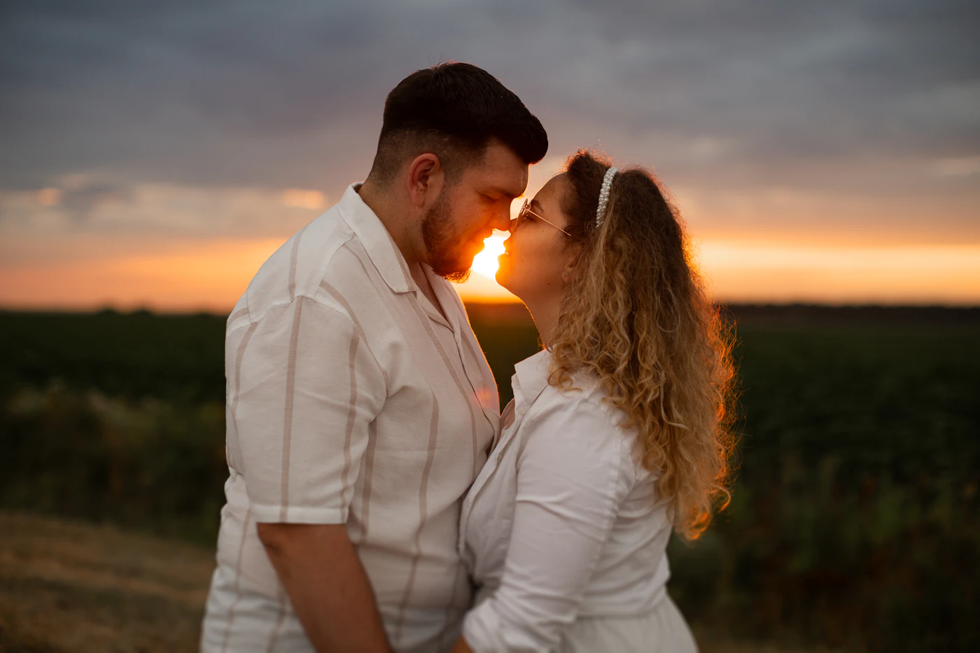 Couple sharing a romantic sunset moment while celebrating their anniversary