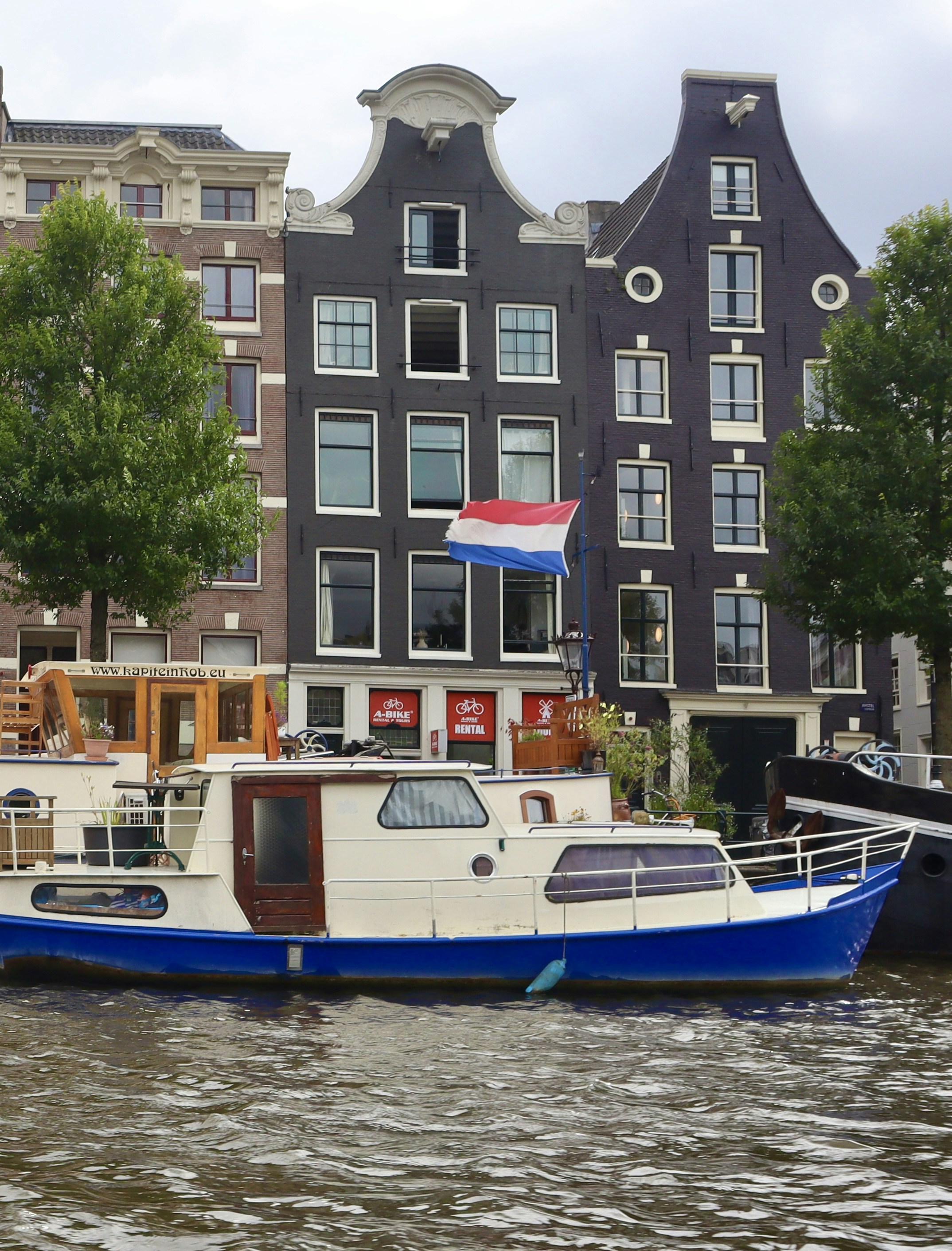 Dutch canal buildings with a boat on the water.