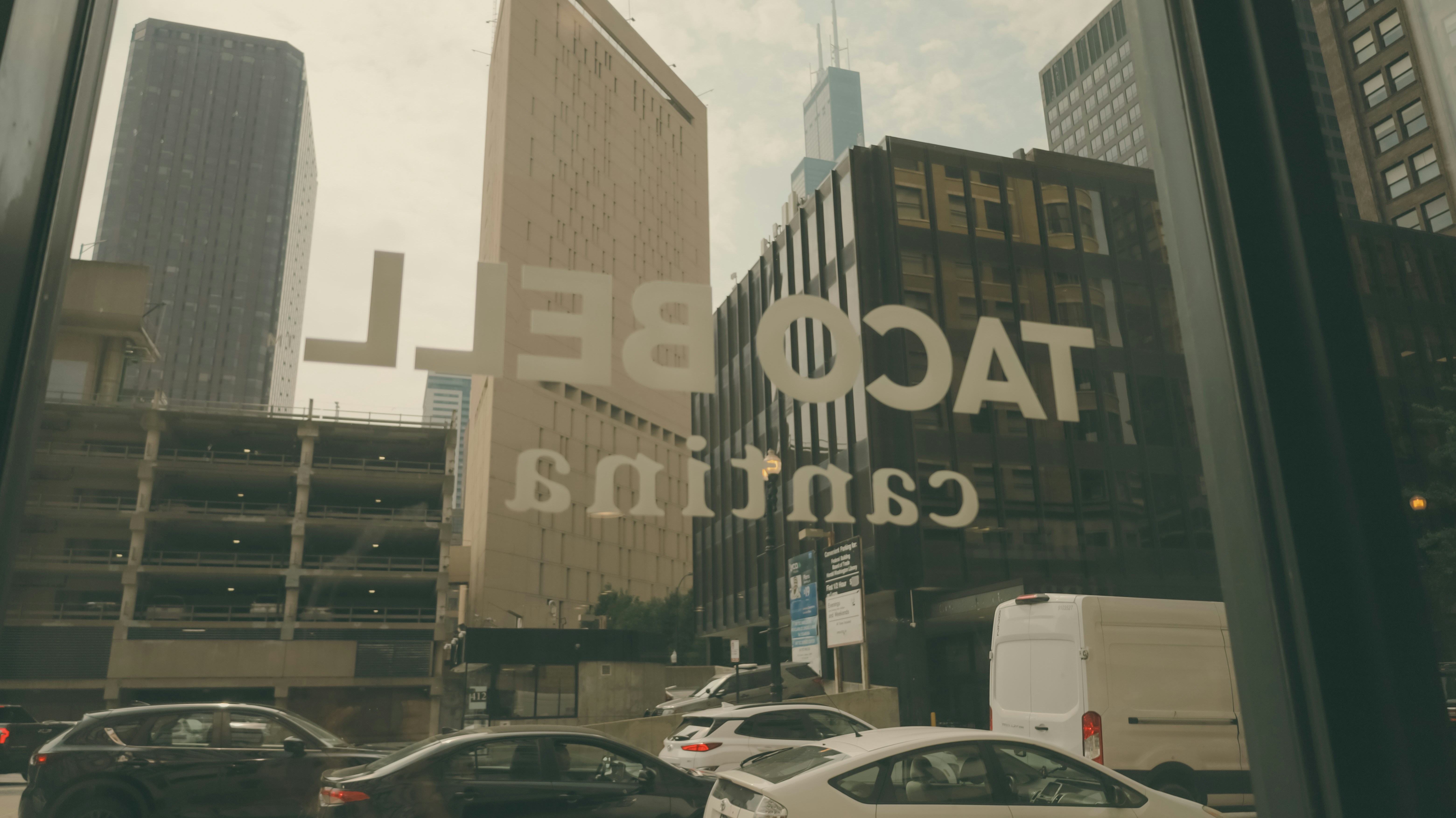 Buildings reflect the taco bell sign.