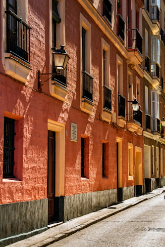 Colonial facade with wrought iron balconies and lanterns on La Ronda