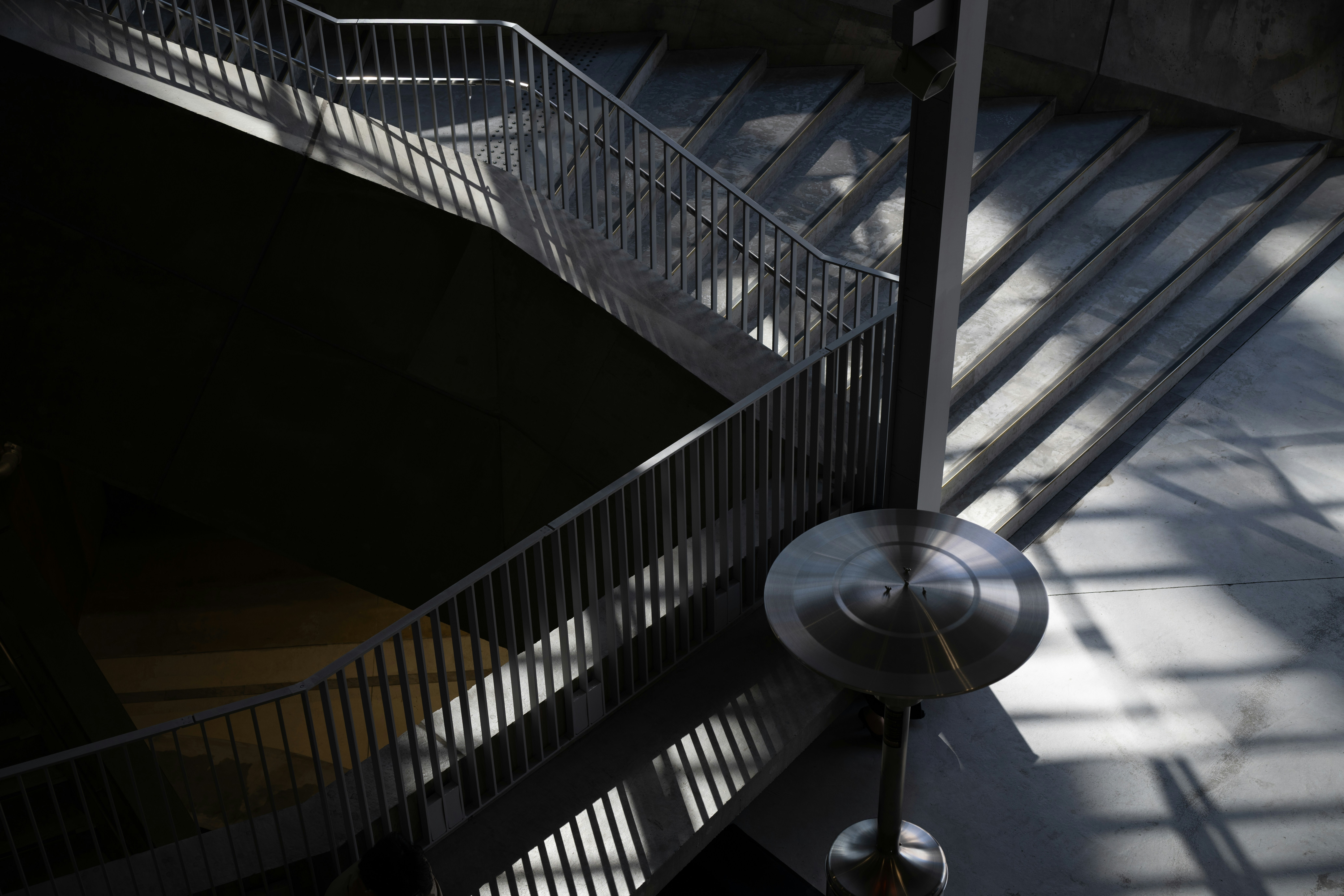 Modern architecture features a staircase and metal supports.
