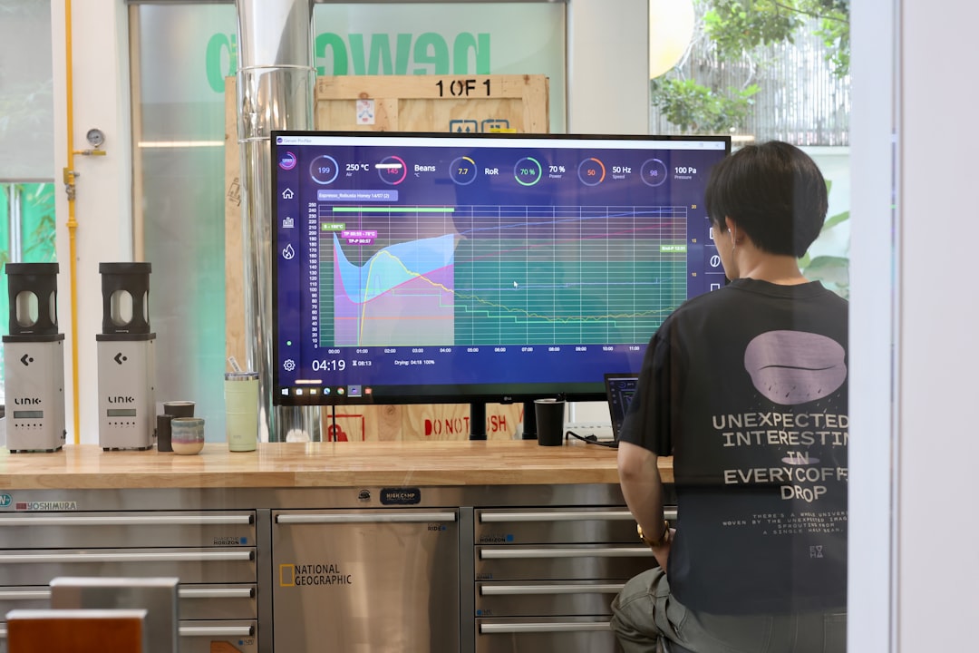 A man monitors data displayed on a computer screen.